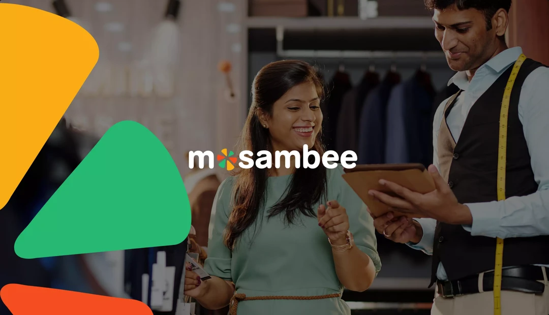 The Mosambee wordmark over a photograph of a shopkeeper serving a customer in a clothing store, framed by the brand's orange and green shapes.
